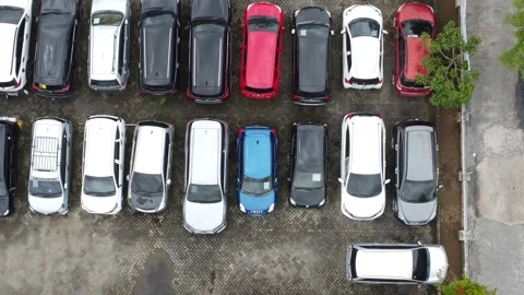 Aerial view of a parking lot lined up with cars for rent Stock Footage 327048634