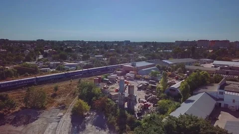 Aerial view of the passenger train on the background of the industrial district Video stock 80891843