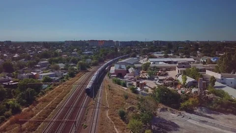 Aerial view of the passenger train on the background of the industrial district Video stock 80893109