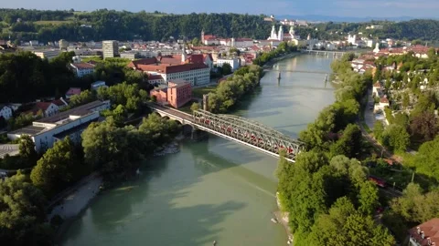 Aerial view of a passenger train crossing the Inn bridge to Passau Stock Footage 339650013