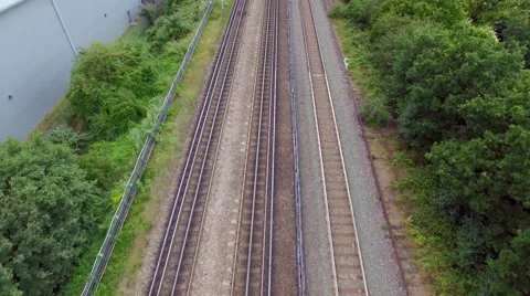Aerial view of passenger train passing at a London city Stock Footage 52546763