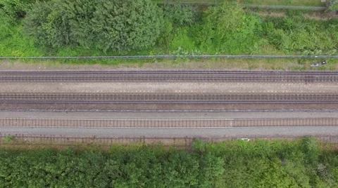 Aerial view of passenger train passing at a London city Stock Footage 52546767