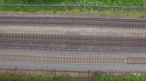 Aerial view of passenger train passing at a London city Stock Footage 52546786