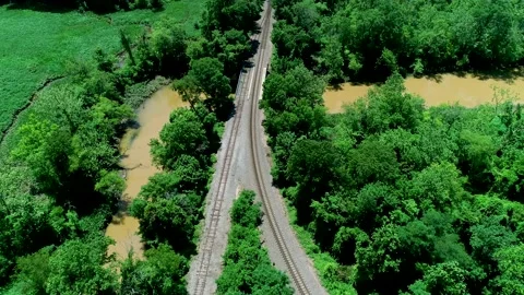 Aerial view of passenger train passing Stock Footage 133858072