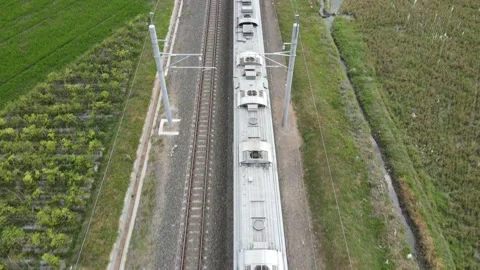 Aerial View of Passenger Train Passing by a Rail in Yogyakarta Indonesia Stock Footage 152694299