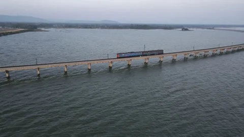 Aerial view of Passenger train run on a beautiful floating railway bridge Stock Footage 160587591