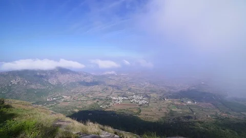 Aerial view of passing clouds and a over a beautiful landscape in Nandi Hills. 動画素材 90943422