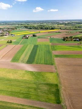Aerial view of patchwork agricultural fields with diverse crop cultivation Stock Photos