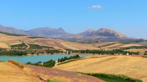 Aerial view of Patchwork crop fields, lake poma and mountains, italy Stock-Footage 124471241