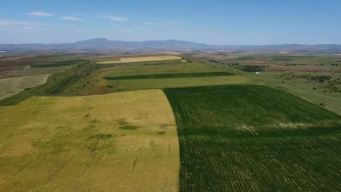 Aerial view of patchwork farm fields and distant mountain ridges in Kazakhstan 動画素材 338120023