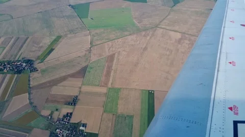 Aerial View of Patchwork Farmland with Airplane Wing Overhead Stock Footage 313922117