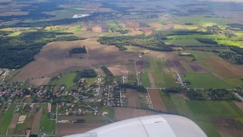 Aerial View of Patchwork Farmland and Landscapes from Airplane Window Stock Footage 312004397