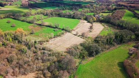 Aerial view of patchwork farmland and countryside fields in Wiltshire England Stock Footage 333893154