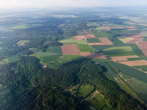 Aerial view of patchwork farmland and forest near Paris, France with villag.. Stock Photos