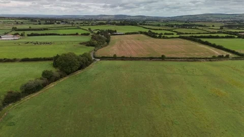 Aerial View of Patchwork Farmland with Fields and Tree Lines Stock Footage 333412902