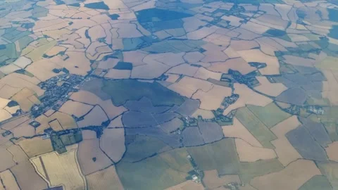 Aerial view of patchwork farmland landscape with varying shades Stock Footage 340106384