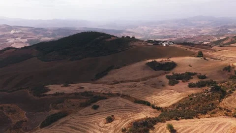 Aerial view of patchwork farmland on rolling hills Stock Footage 331226614