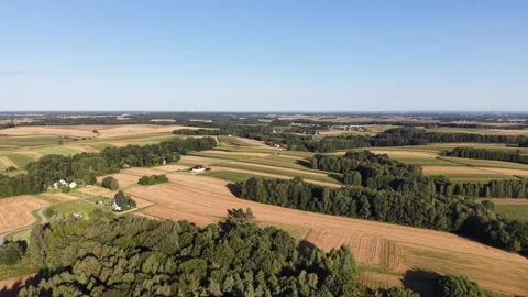 Aerial view of patchwork farmland with a rural village Stock Footage 348389437