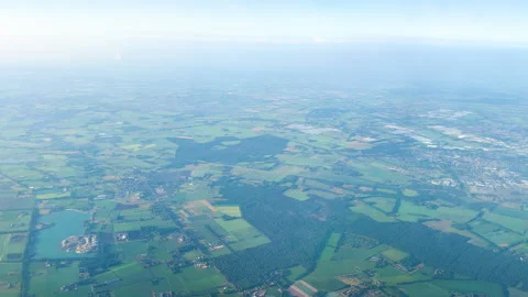 Aerial view of patchwork farmland under hazy sky Stock-Footage 331396418