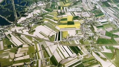 Aerial view of patchwork farmland, villages, roads and a dark lake near Krakow Video stock 337253370