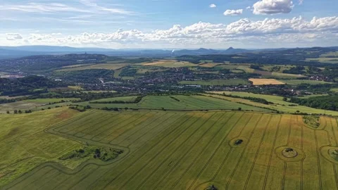 Aerial view of patchwork farmland with winding crop rows, circular fields, Stock Footage 342358642