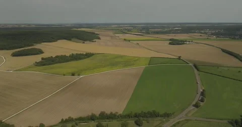 Aerial view of patchwork fields and winding road, France. Stock Footage 284842884