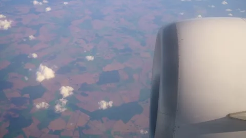 Aerial View of Patchwork Fields and Clouds During Flight Over Rural Landscapes Stock Footage 309627952