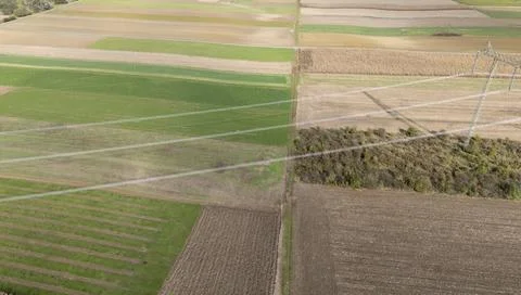 Aerial view of patchwork fields showcasing vibrant greens and browns, Stockfoto's