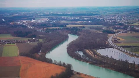 An aerial view of the patchwork of fields, small towns, forests, and a Stock Footage 274053804