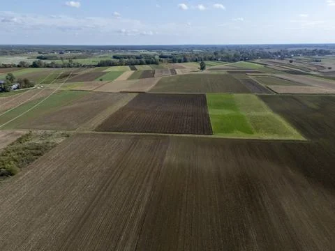 Aerial view of patchwork fields in vibrant colors, showcasing agricultural Stockfoto's
