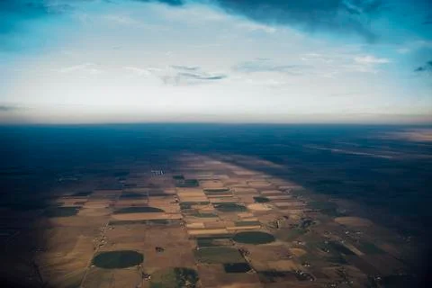 Aerial view of patchwork landscape against cloudy sky 스톡 사진