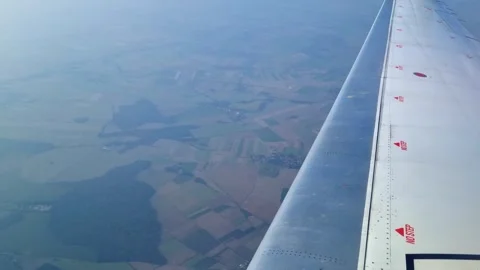 Aerial View of Patchwork Landscape from Airplane Wing During Daytime Flight Stock Footage 313903751