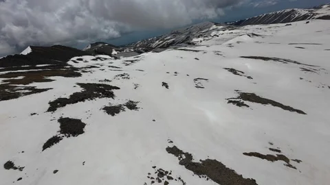 Aerial view of patchy snow on the high slopes of Mount Aragats Stock Footage 343876407