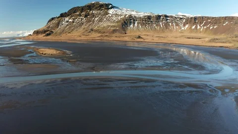 Aerial view of patterns of Icelandic rivers flowing into the ocean. Iceland in Stock Footage 124868448