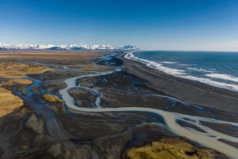 Aerial view of patterns of Icelandic rivers flowing into the ocean. Iceland in Stock Photos