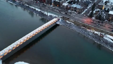 Aerial View of Peace Bridge Calgary Tilt Down to Pan Up Over Bow River Stock Footage 333548749