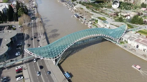 Aerial view of the Peace bridge over Kura Mtkvari river in Tbilisi, Georgia Stock Footage 314697649