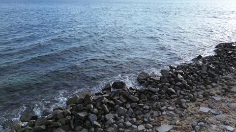 Aerial view of pebble beach with blue sea Stock-Footage 252952166