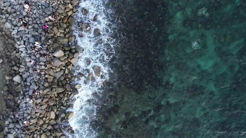 Aerial view of pebble beach with blue sea Video stock 255099481