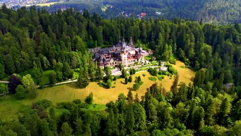 Aerial View of Peles Castle Surrounded by Carpathian Forests in Romania Stock-Footage 341210651