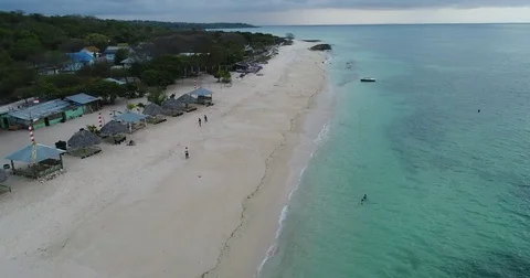 Aerial view of people on the beach in Indonesia with thunderstorm brewing Stock-Footage 81687053