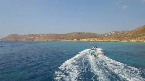 Aerial view of people being pulled with floats at the cost of Mýkonos, Greece. Stock Footage 148996795