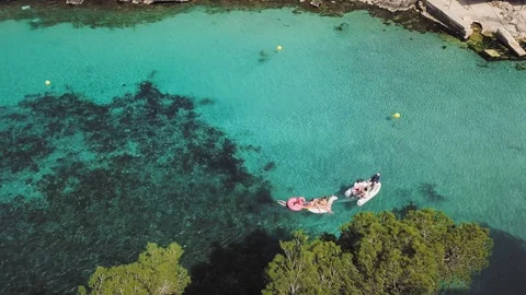 Aerial view of people with floaties and a dinghi, bay of Cala Pi, Mallorca Stock-Footage 120047571