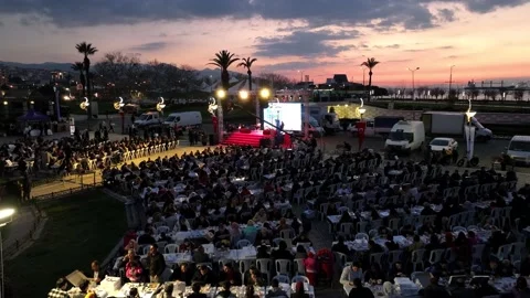 Aerial view of people praying and fasting together at iftar in Ramadan under the Stock Footage 237783225