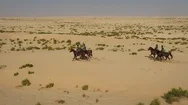 Aerial View Of People Riding Horses In The Desert Of Al Khatim In Abu Dhabi. Stock Footage
