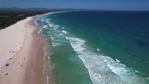 Aerial View Of People Sunbathing On Sandy Shore Of Belongil Beach In Byron Bay 動画素材 329640941