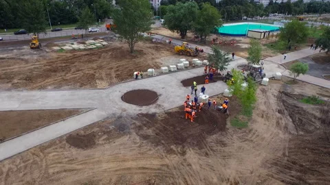 Aerial view people work at the construction site. Shovels gather sand. Video stock 93810480