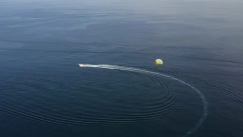 Aerial view of a person doing parasail in Sicily, Italy. Видео 234445679