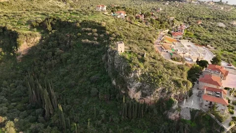 Aerial view of Petraea Tower during sunset in the town of Kardamyli on the Mani Stock-Footage 302556277