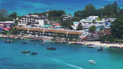 Aerial View of Phi Phi Island Harbor with Boats and Waterfront Stock Footage 297409609